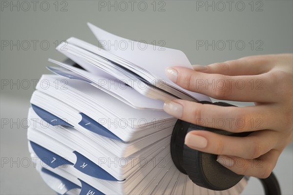 Woman holding card in rotary card file.