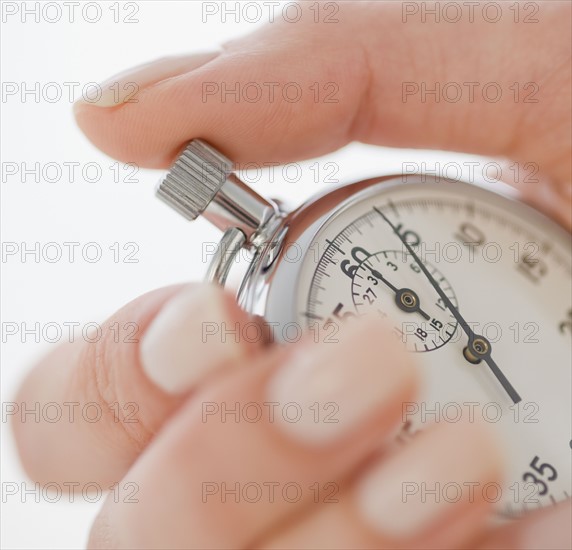 Woman holding stopwatch.