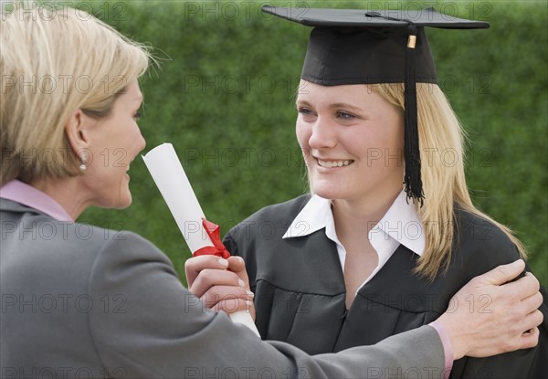 Mother congratulating graduate daughter.