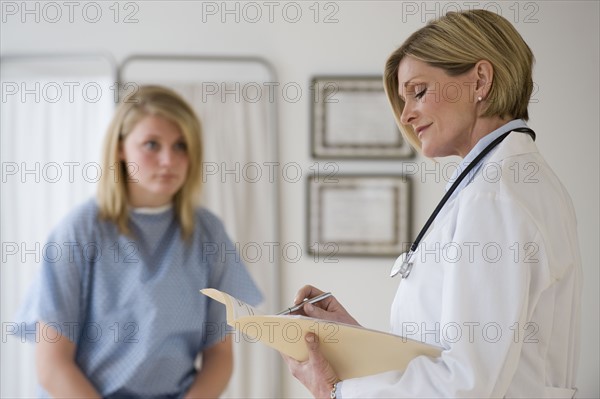 Female doctor reading chart.