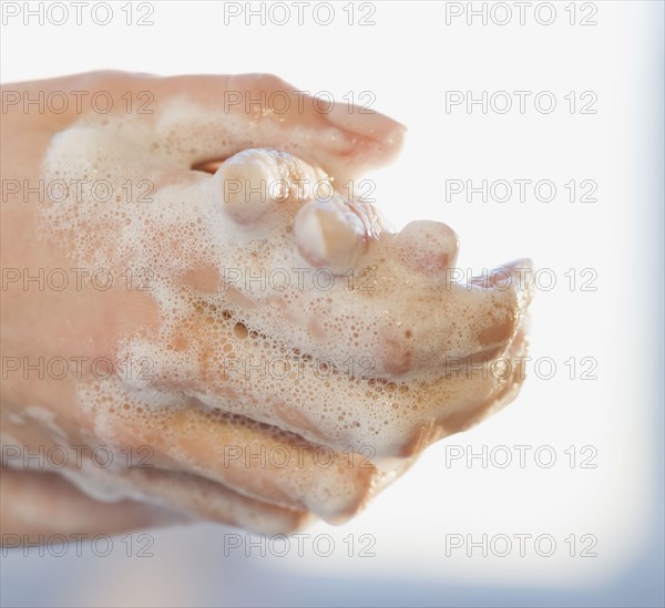 Close up of woman washing hands.