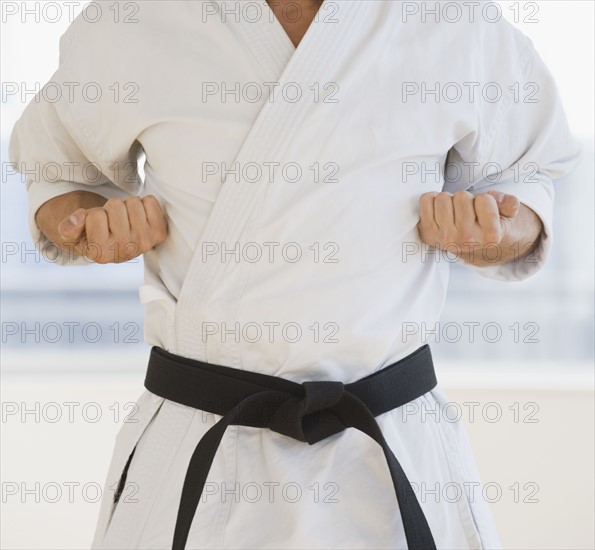 Male karate black belt in fighting stance.