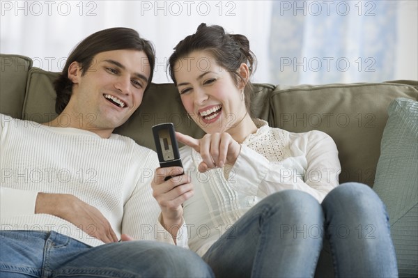 Couple looking at cell phone.