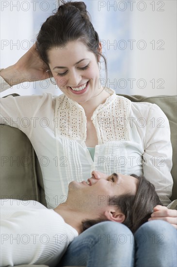 Man laying in girlfriend’s lap.