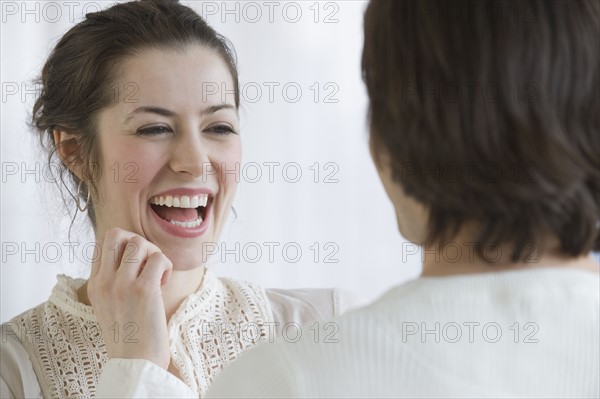 Woman laughing next to boyfriend.