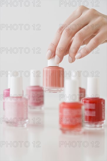 Woman choosing nail polish.