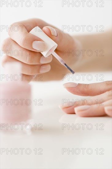 Woman painting fingernails.