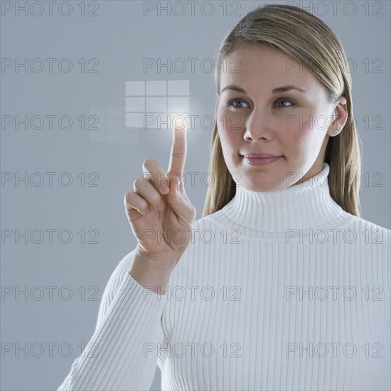 Woman touching lighted display.
