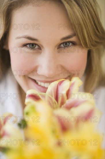 Woman smelling flower.