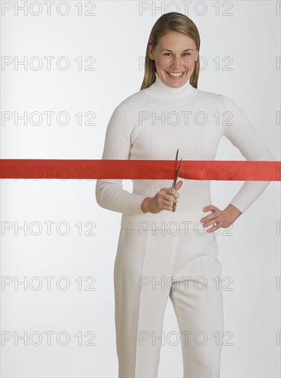 Woman cutting red tape.