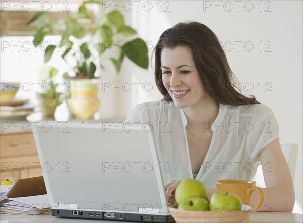 Woman looking at laptop.