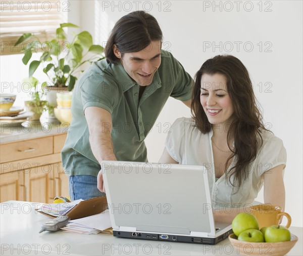 Couple looking at laptop.