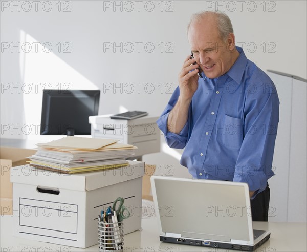 Senior businessman talking on cell phone.