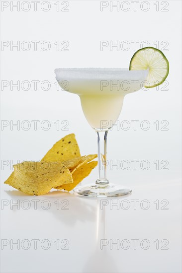 Margarita next to tortilla chips.