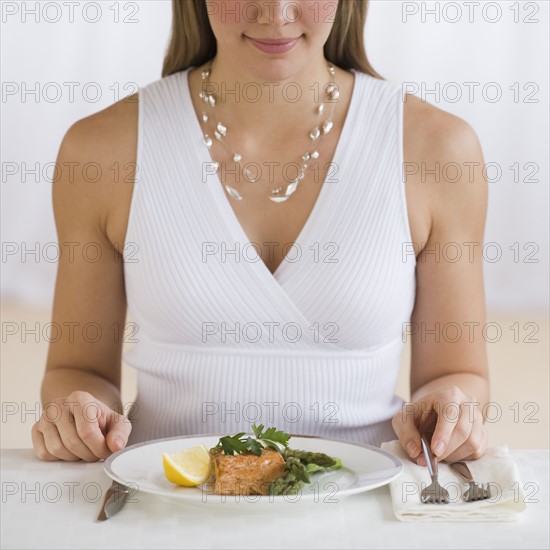 Woman sitting at dinner table.