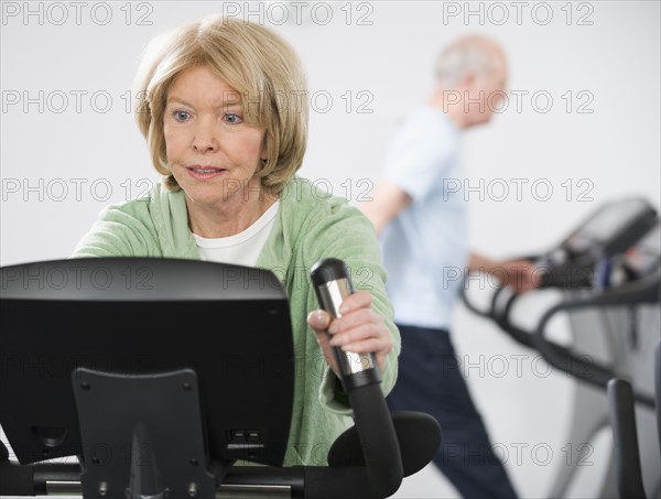 Senior woman on exercise machine.