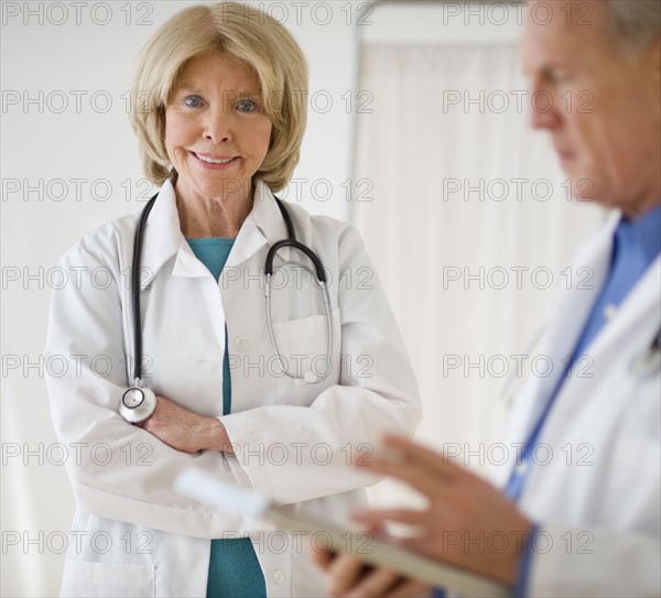 Senior female doctor with arms crossed.