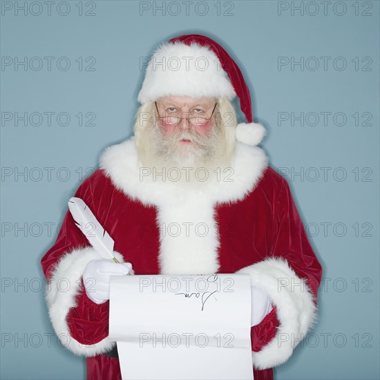 Santa Claus writing list of names.