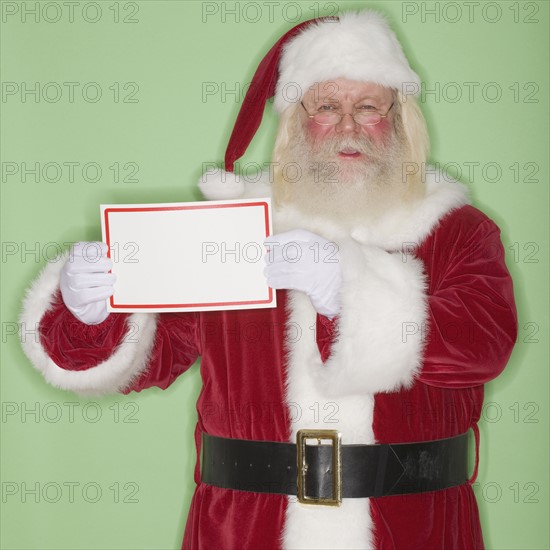 Santa Claus holding blank sign.
