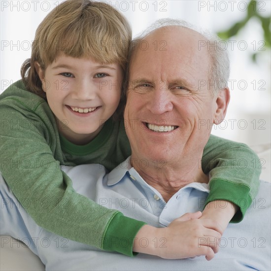 Grandfather and grandson hugging.