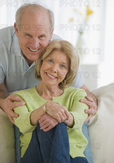 Senior man hugging wife.