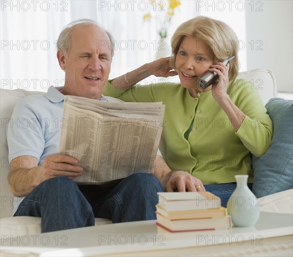 Senior couple relaxing on sofa.