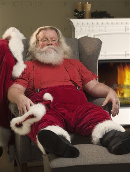 Santa Claus relaxing in armchair.