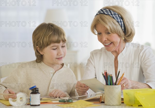 Grandmother and grandson scrapbooking.