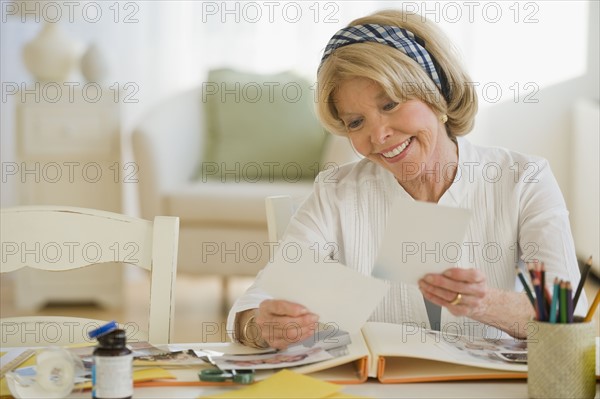 Senior woman looking at photographs.