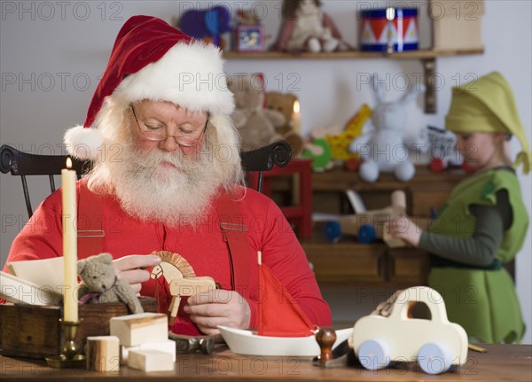 Santa Claus looking at toys.