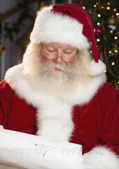 Santa Claus reading list of names.