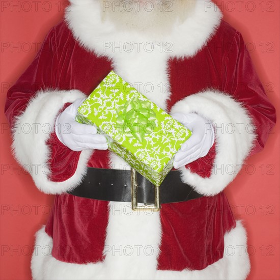 Santa Claus holding gift.