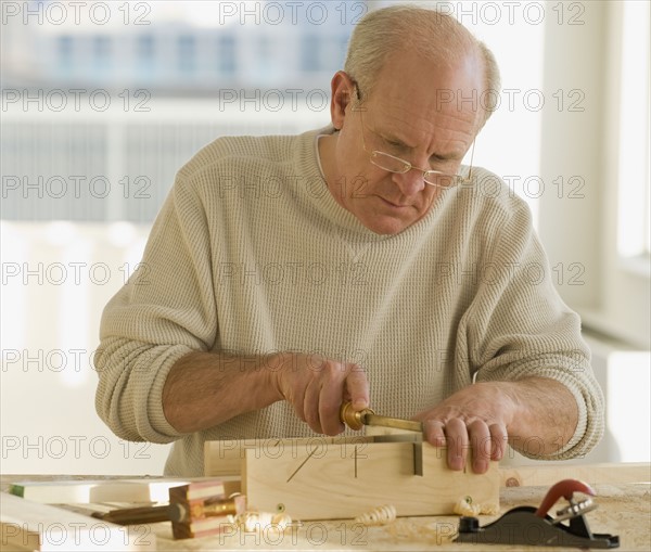 Senior man woodworking.