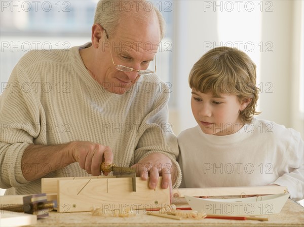 Grandfather and grandson woodworking.