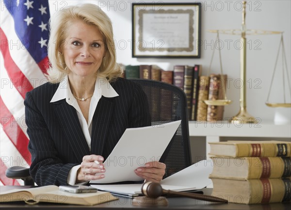 Businesswoman holding paperwork.