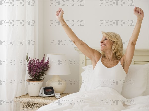 Woman stretching in bed.