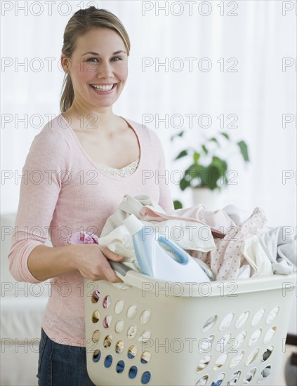 Woman holding laundry basket.