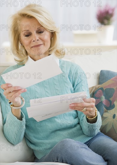Senior woman reading mail.