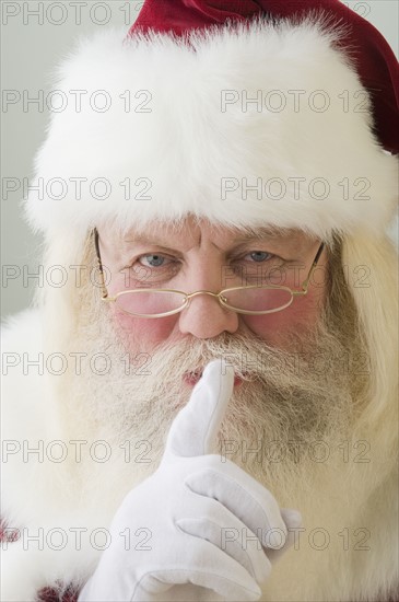 Close up of Santa Claus shushing.