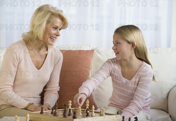 Grandmother and granddaughter playing chess.