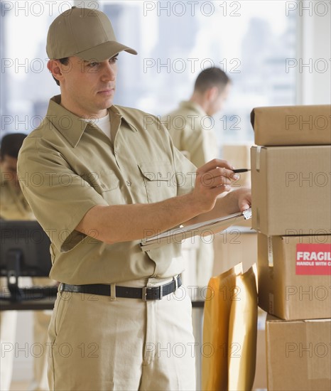 Delivery man making package.