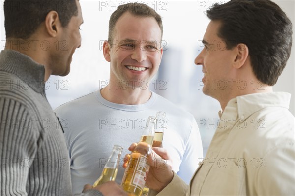 Multi-ethnic men drinking beer.