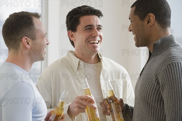 Multi-ethnic men drinking beer.