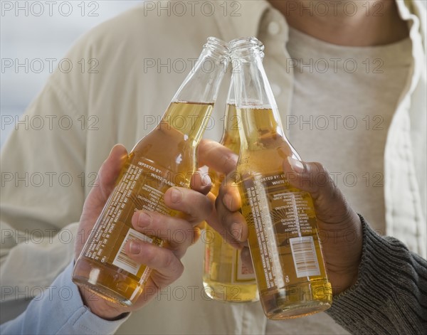 Multi-ethnic men toasting with beer.