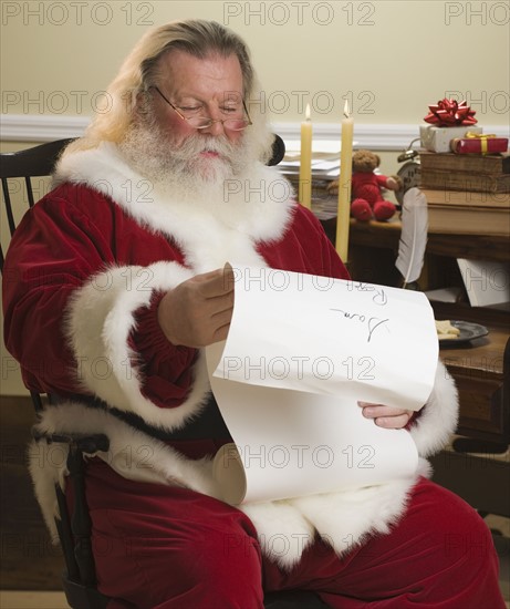 Santa Claus reading list of names.