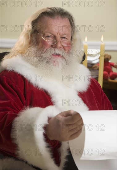 Santa Claus reading list of names.