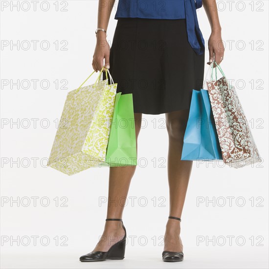 African woman holding shopping bags.