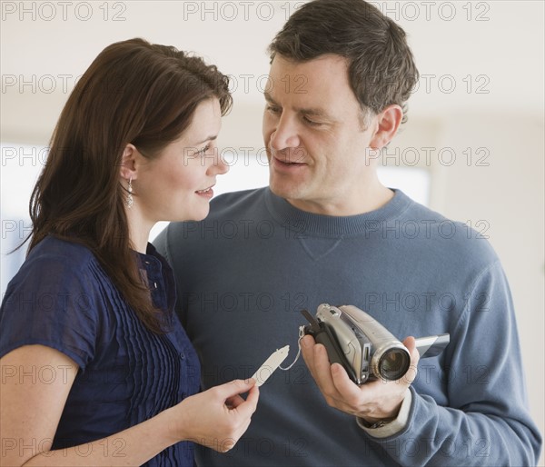 Couple shopping for video cameras.