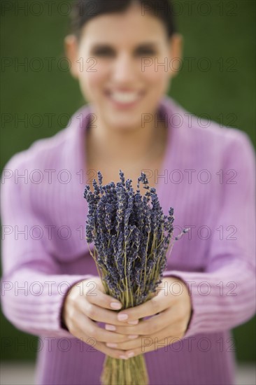 Woman holding bunch of lavender.