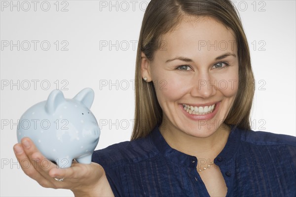 Woman holding piggy bank.